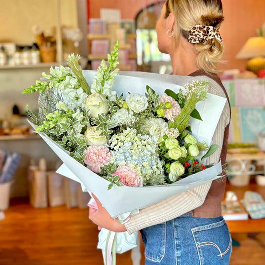 Person holding a massive bouquet of beautiful, fresh, flowers
